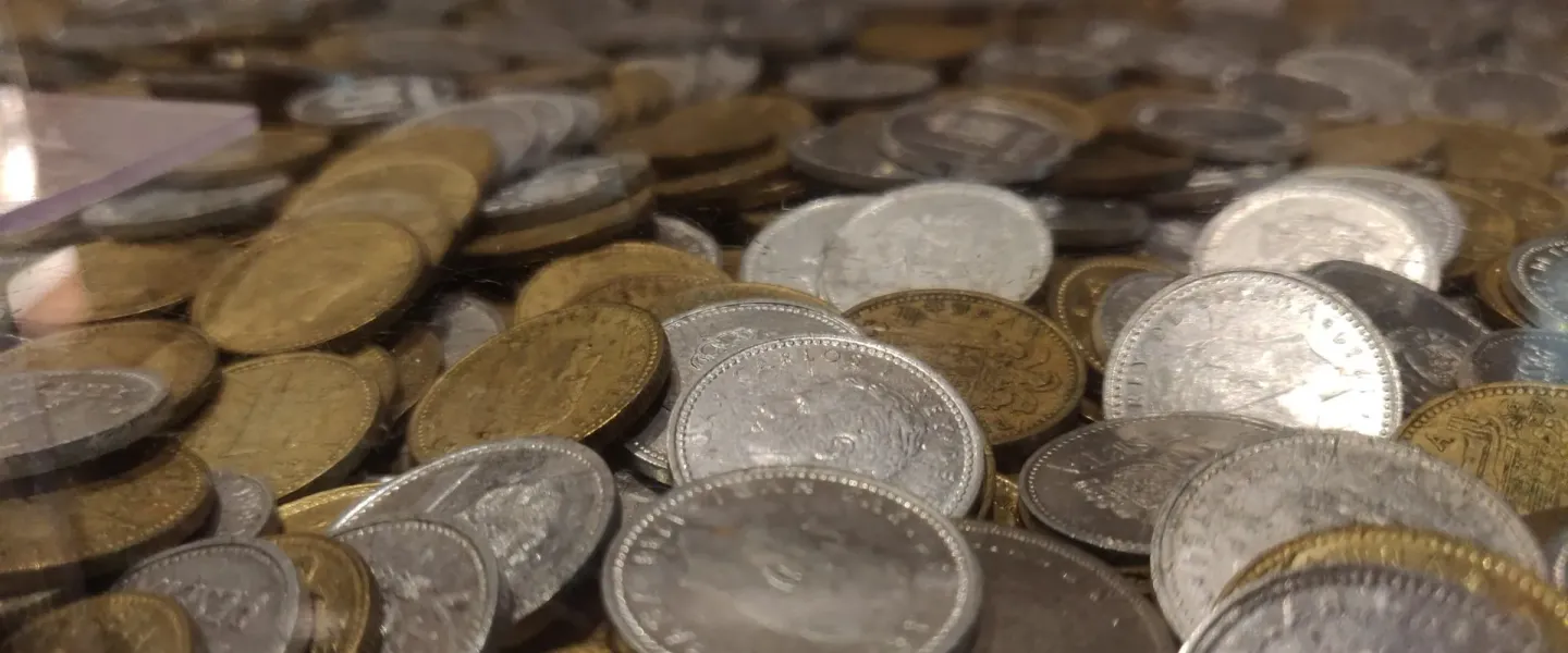 Close-up of a pile of old silver and bronze coins